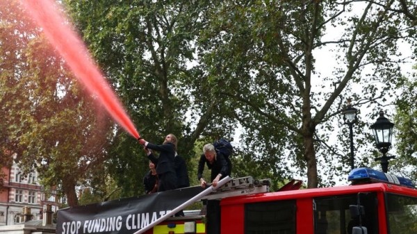 Extinction Rebellion protesters use fire engine to spray Treasury with fake blood
Extinction Rebellion protesters use fire engine to spray Treasury with fake blood